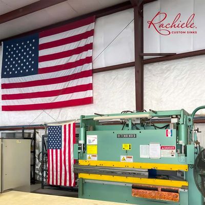 Two large U.S. flags showing in our custom workstation sink artisan shop. 