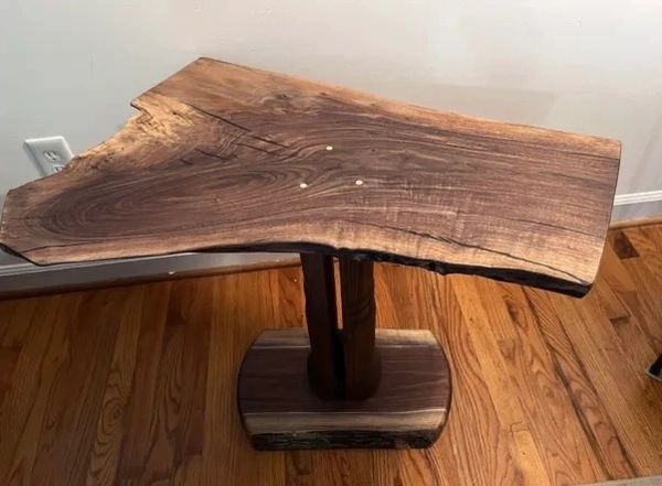 Rustic wooden side table with natural edges and dark wood grain.