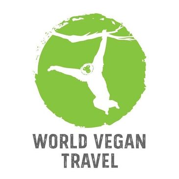 Logo of World Vegan Travel with a person hanging from a branch inside a green circle.