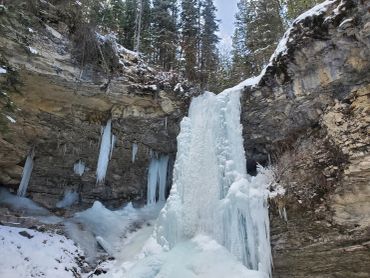 A frozen waterfall representing strength, stillness, and resilience through every season.