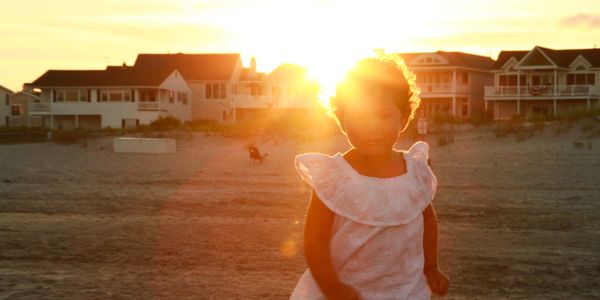 Child on the beach during sunset