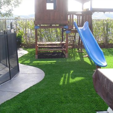 Synthetic grass used around a children's playground