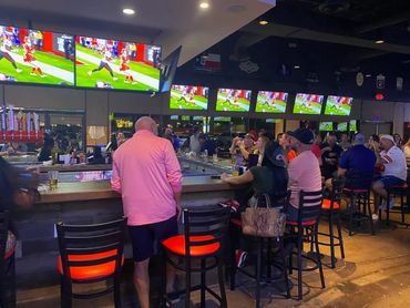 Chief fans watching sports and having a drink at Arrowhead