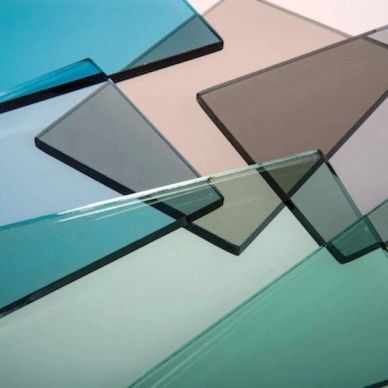Various tinted glass sheets overlapping in different shades.