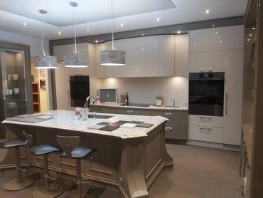 Modern kitchen with a large island and three pendant lights.