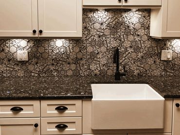 Kitchen backsplash with intricate hexagonal tile patterns and farmhouse sink.