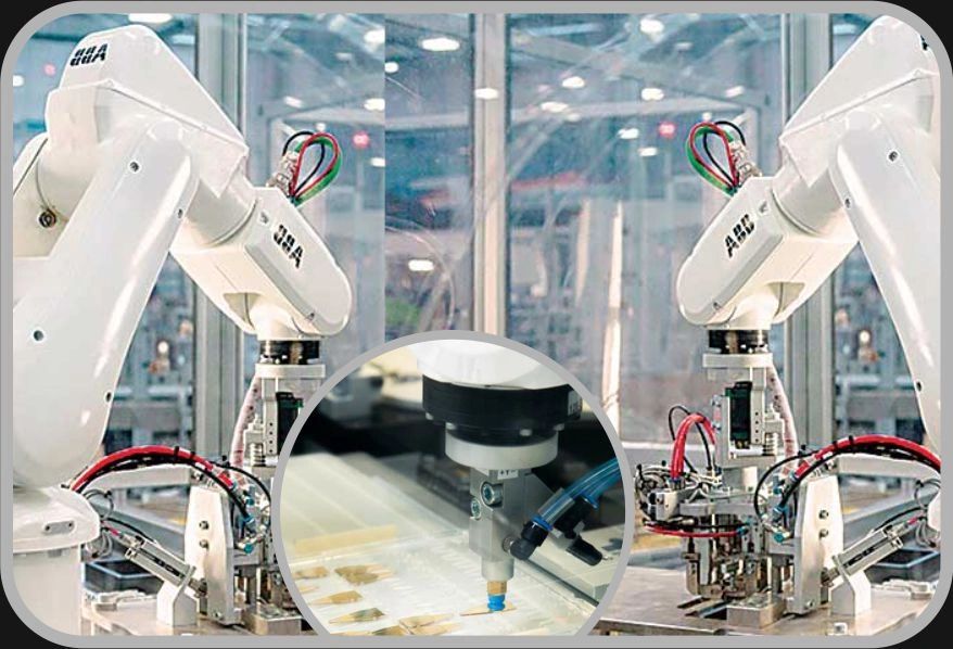 Robotic arms operating in a manufacturing environment.
