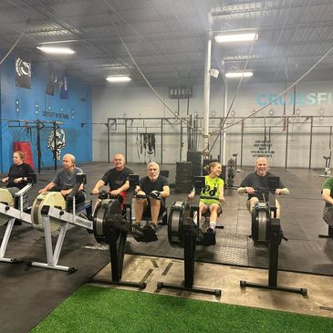 People with young onset Parkinson's Disease rowing at a high intensity workout class.