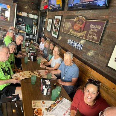 Group of people enjoying a meal together in a cozy restaurant.
