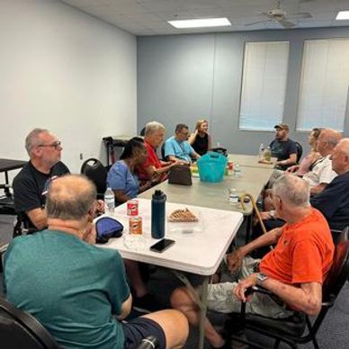 A group of people gathered around a table in a meeting room.