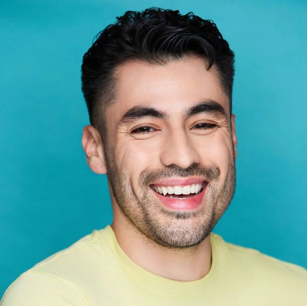 Happy man smiling against blue background.