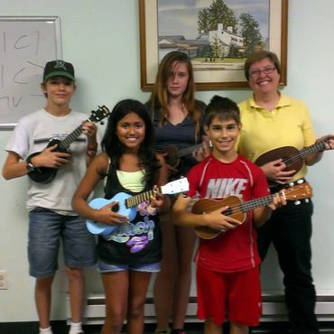 Students have fun learning to play ukulele in a group class called, Ukulele Club.