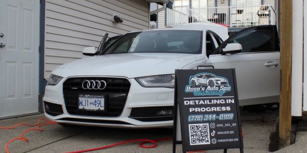White Audi car being detailed at a home auto spa.