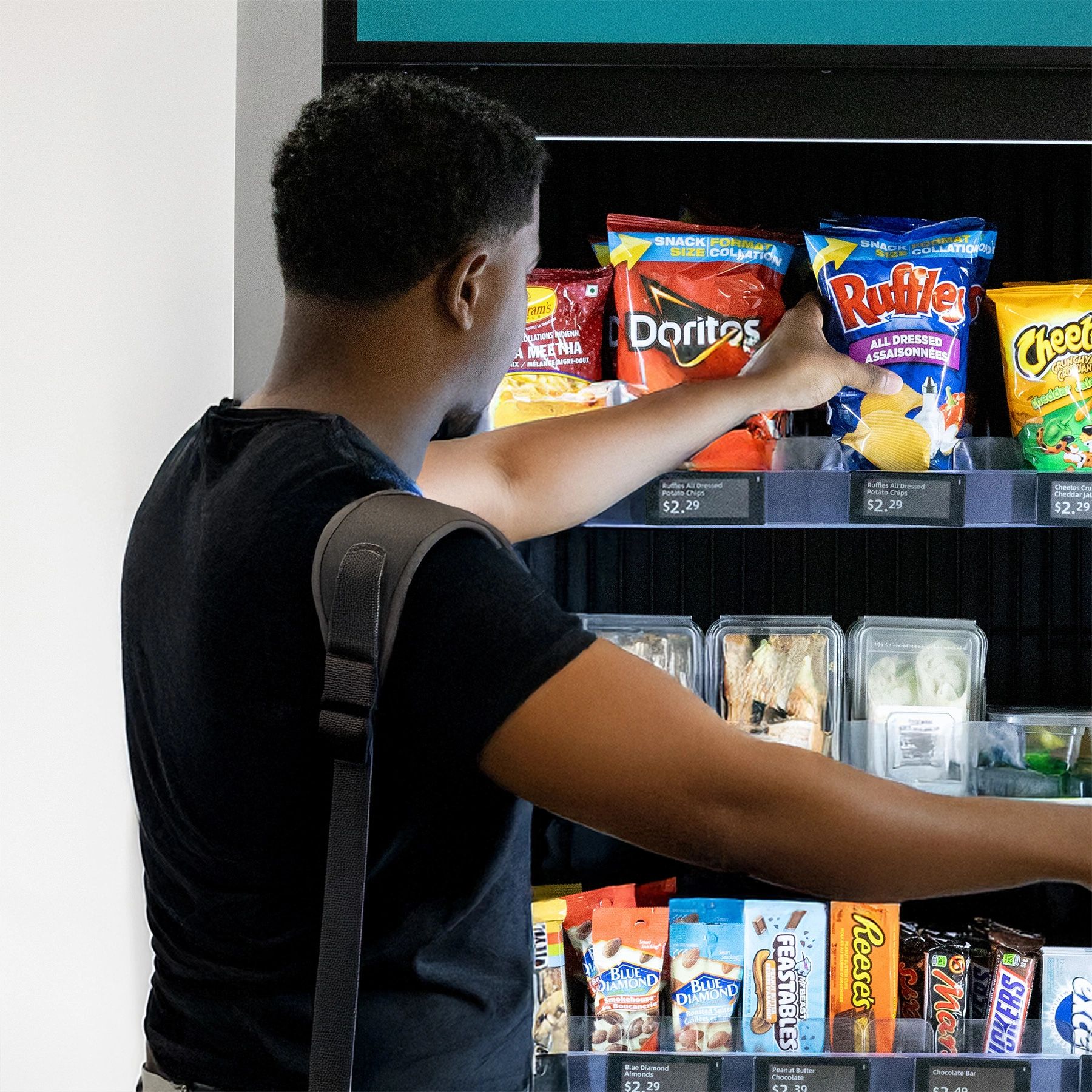 Customer choosing snacks from a smart vending micro market