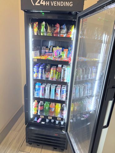 Open Quick S-Mart machine stocked with snacks and drinks