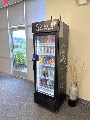 Quick S-Mart smart vending machine by a glass entry in a Houston-area office