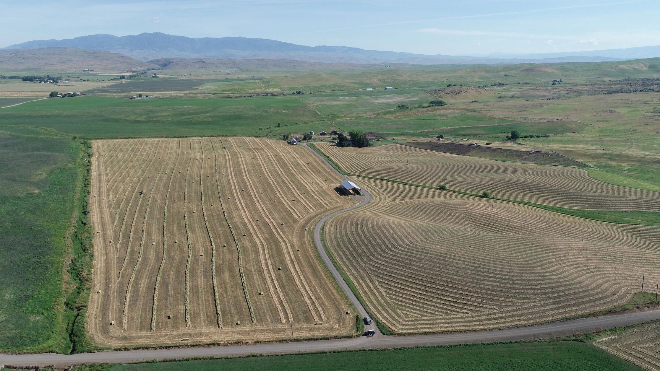 Hay field being raked and baled outside of Midvale, Idaho - SX Ranch
