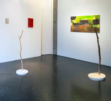 Two sculptures of  pieces of driftwood set into  plaster casts made of spring water. two paintings h