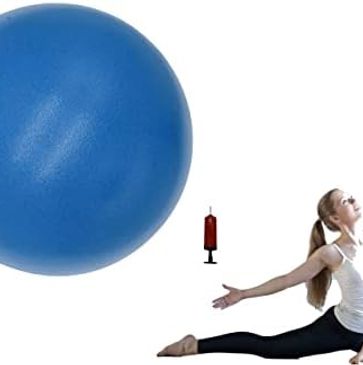 A woman is doing yoga with an exercise ball.