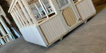 Freshly built greenhouse shed with wood frame, shown inside manufacturing shop – American Barn Co