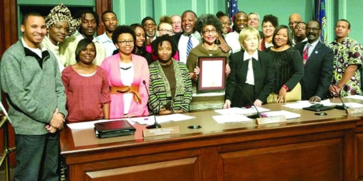 Dr. Germon Miller (Mama G) holding a proclamation from the City of Columbia, SC