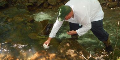 John Dolan, secretary of the CRTU, collects water samples from a tributary to Glade Run in a remote 
