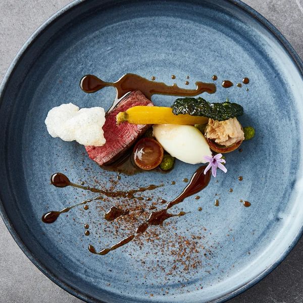 Blue plate of food with meat and vegetables