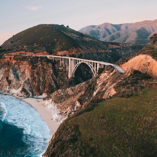 bridge connecting mountains along the ocean