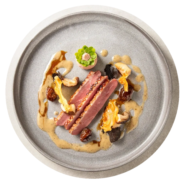 Khaki colored plate of food with meat, veggies, and sauce