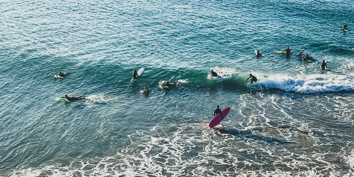 drone view of surfers in the ocean