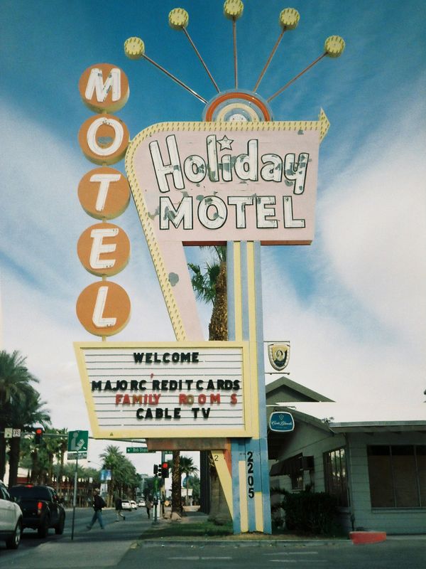 1970's holday motel sign along road