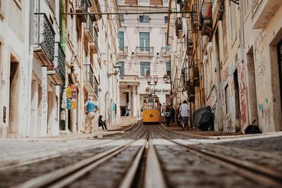 a street car coming down a historic street in Lisbon Portugal