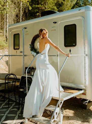 bride climbing into a luxury restroom trailer