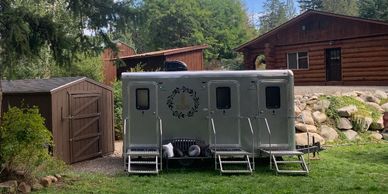 three stall restroom trailer set up at a beautiful farm