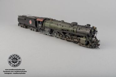 Detailed model of a vintage steam locomotive and tender on a plain background.