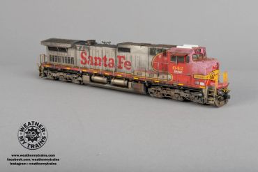 Detailed model train locomotive with Santa Fe livery on a plain background.