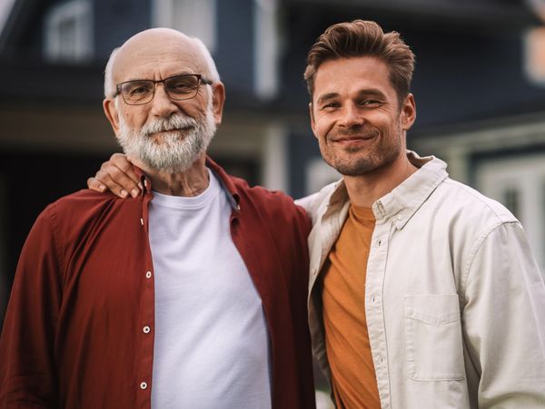 Portrait of a Happy Senior Father or Grandparent Posing Together with His Handsome Adult Son
