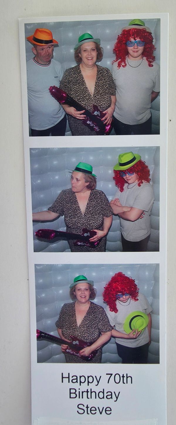 Three people in festive hats celebrating Steve's 70th birthday.
