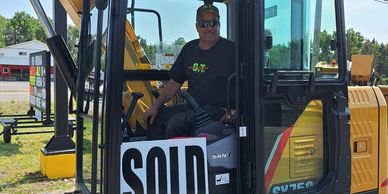 Photo of Greg Long taking delivery of his new SANY SY75C excavator