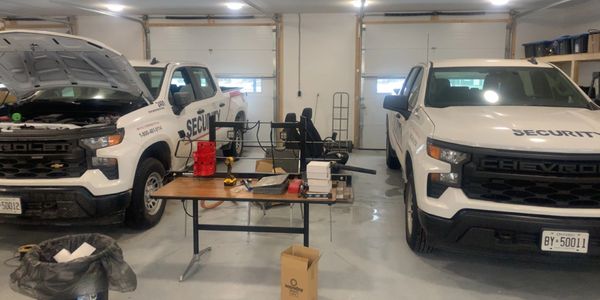 Two of seven security trucks receiving installation of custom lighting and safety lighting systems.