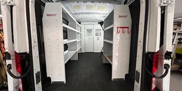 Photo of install of bulkhead divider, shelving and roof mount ladder rack on commercial vehicle.