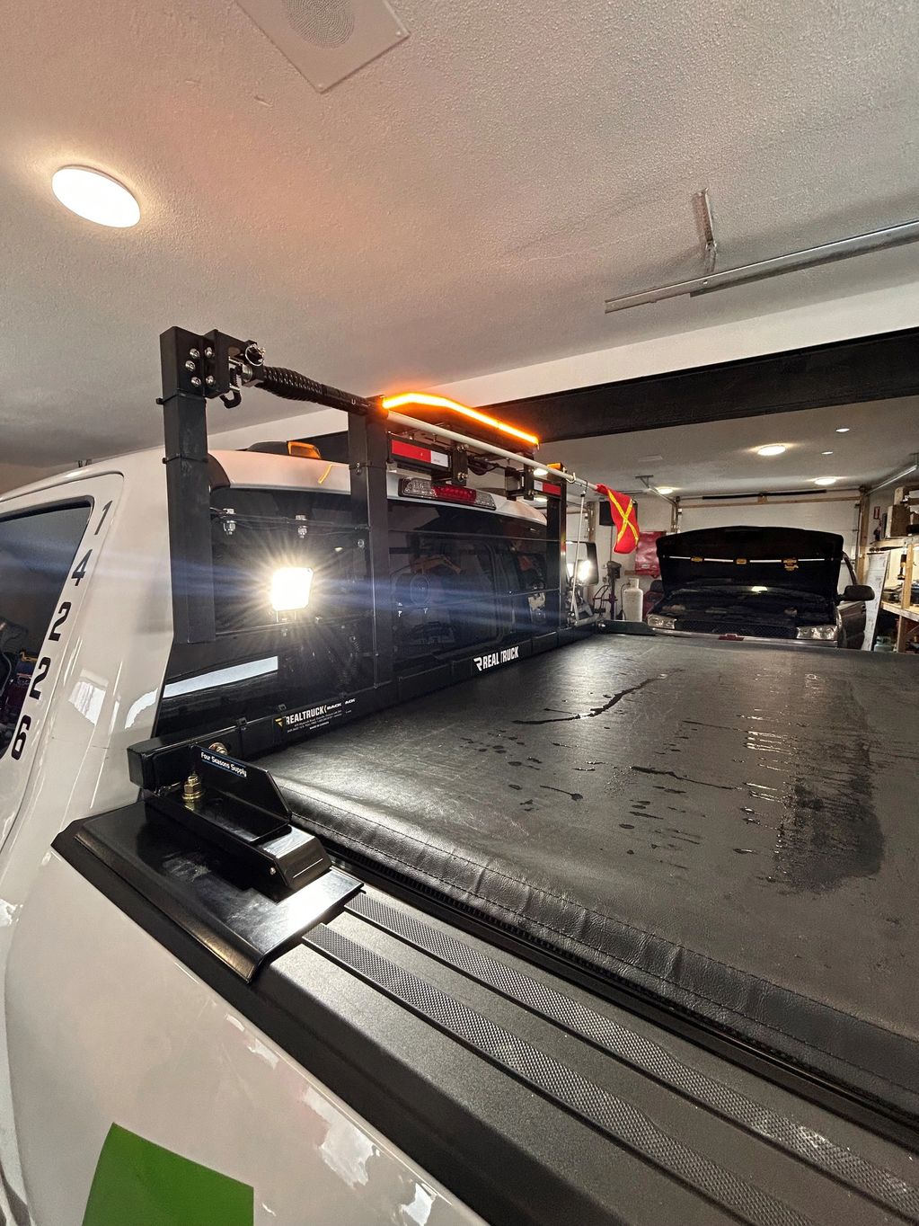 Site specific build, Real Truck rack with Low profile amber beacon, safety whip and reverse lights.