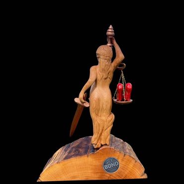 A custom designed and hand carved award featuring Lady Justice, with traditional and unique features
