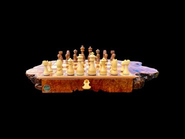 Front view of the custom chess board, with both sets of pieces in starting position.