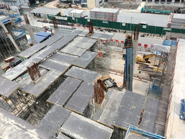 View of construction site with concrete slabs and scaffolding.