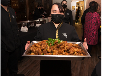 Catering staff with a food tray.