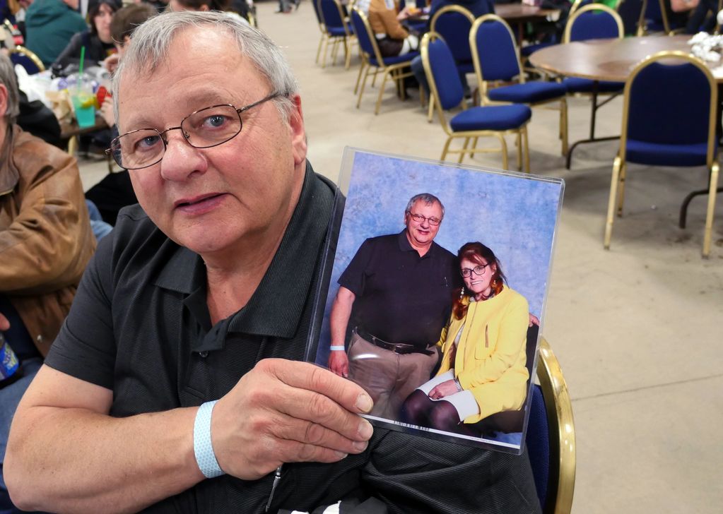 Dennis Feduk holding a photo of him and Margot Kidder, Regina Comic Expo, photograph by Dianne Ouell