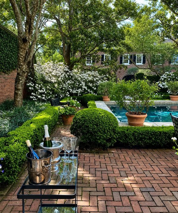 Elegant garden patio with a pool and champagne setup.