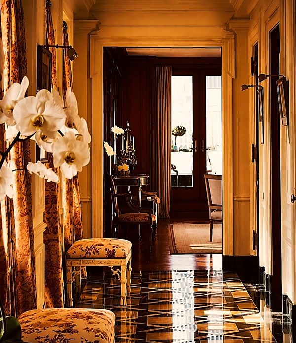Elegant hallway with floral decor and polished floor.