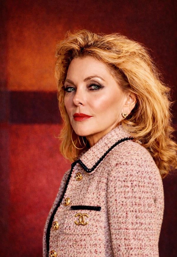 Elegant woman with blonde hair and a tweed jacket.